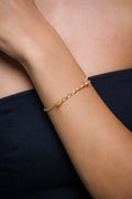 AEJL handmade Gold bracelet on a person's wrist with a