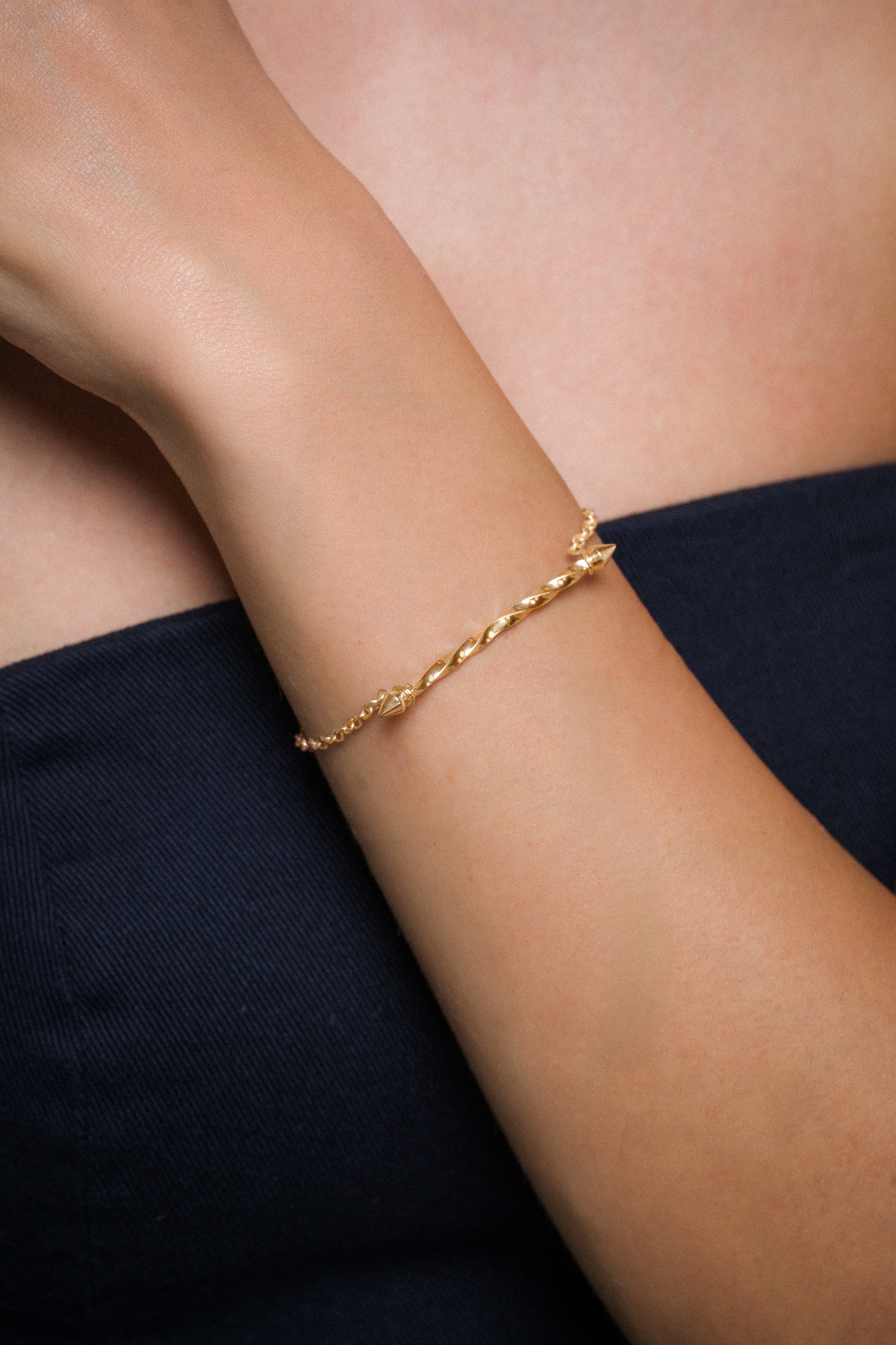 AEJL handmade Gold bracelet on a person's wrist with a