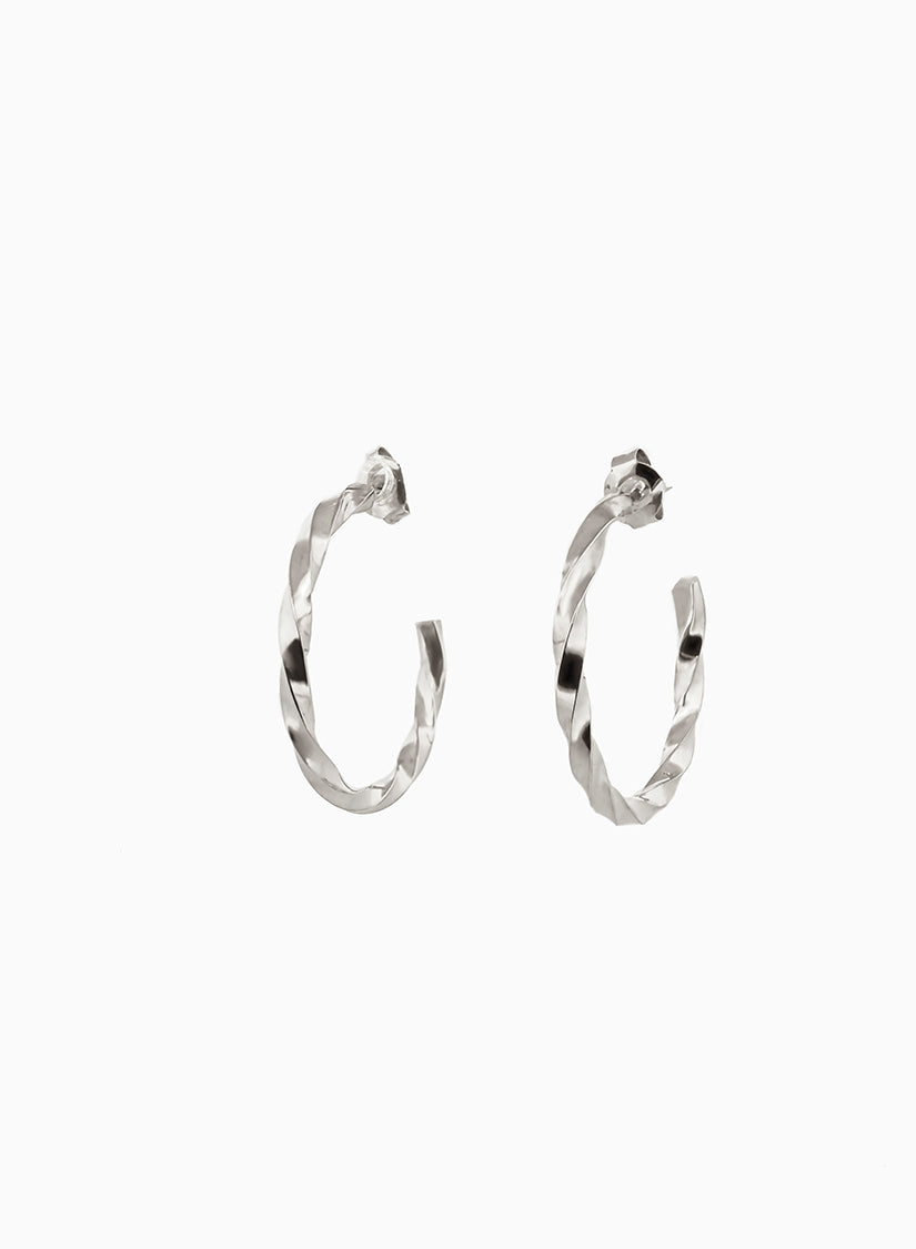 Pair of twisted silver hoop earrings on a white background