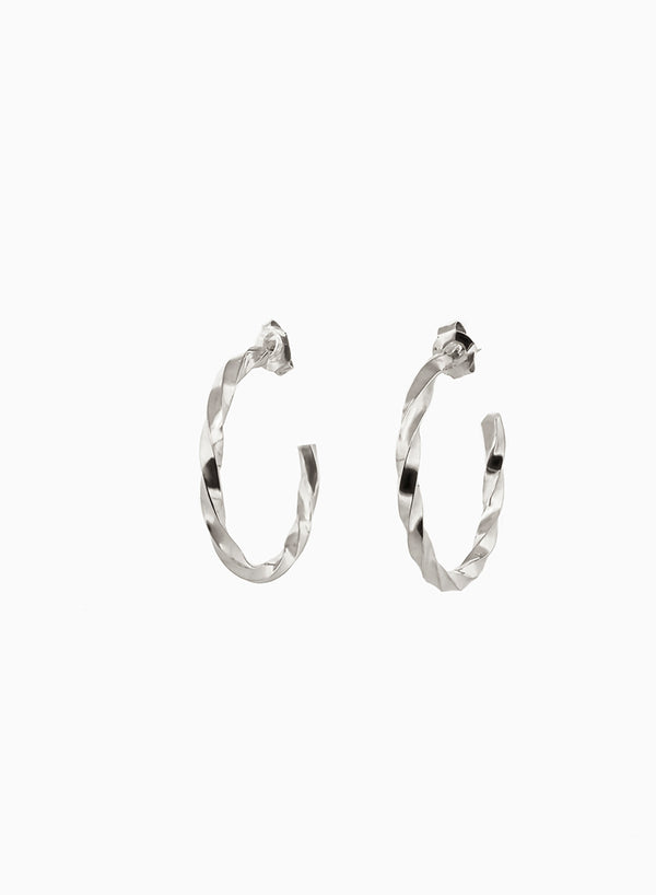 Pair of twisted silver hoop earrings on a white background