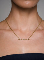 Load image into Gallery viewer, Gold Illusion necklace on a person with a neutral background
