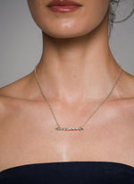Load image into Gallery viewer, Necklace with a bar pendant on a person against a neutral background
