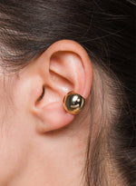 Load image into Gallery viewer, Close-up of an ear wearing a gold sphere ear cuff.

