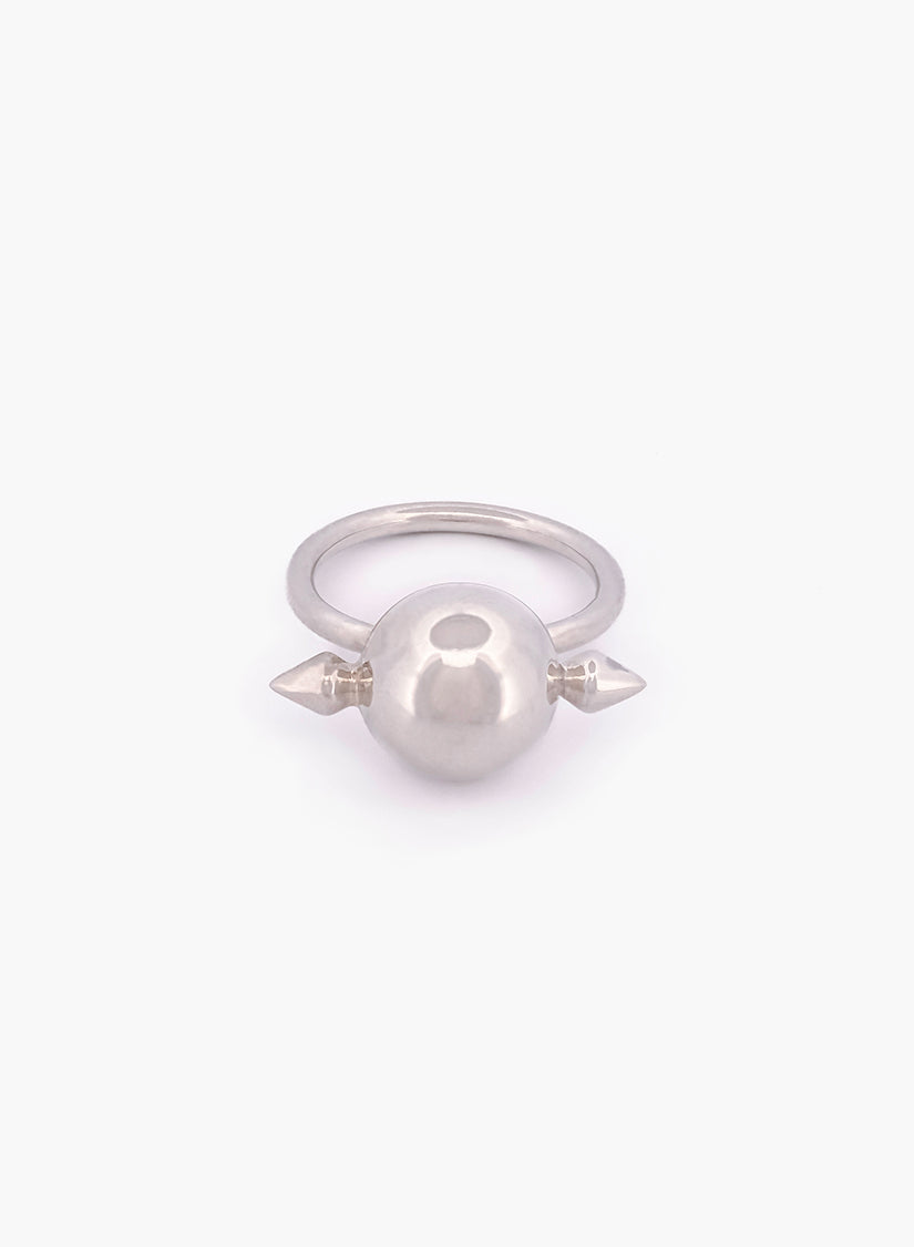 Silver ring with a central sphere and two spikes on a white background
