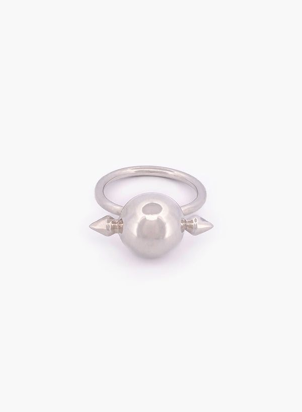 Silver ring with a central sphere and two spikes on a white background