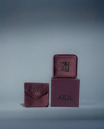 Load image into Gallery viewer, Plum velvet jewellery box set with 'AEJL' branding on a grey background
